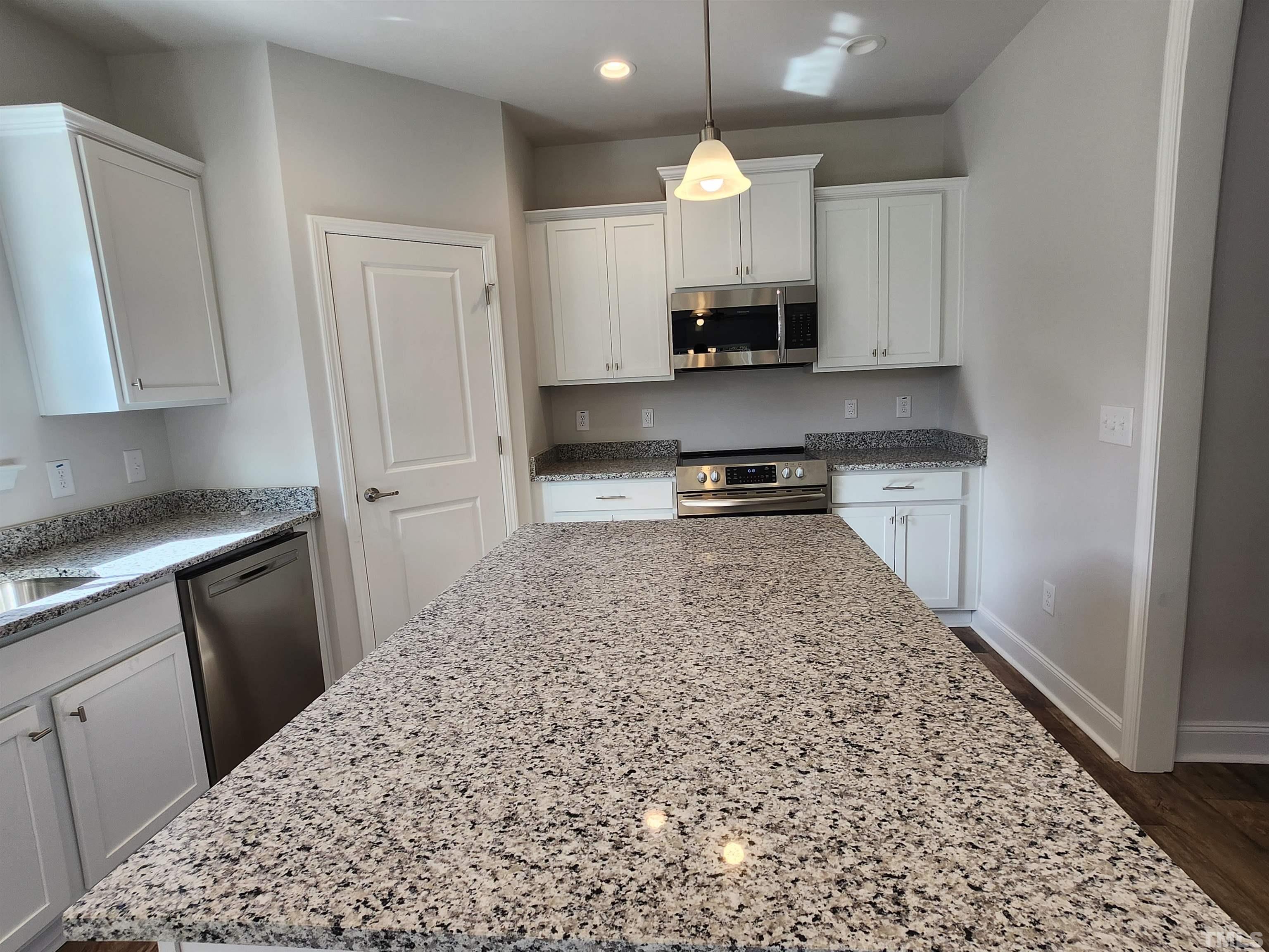 243 Spring Flowers Drive Cameron, NC 28326 - Photo 6 of 30 a kitchen with stainless steel appliances granite countertop a stove a sink and a refrigerator