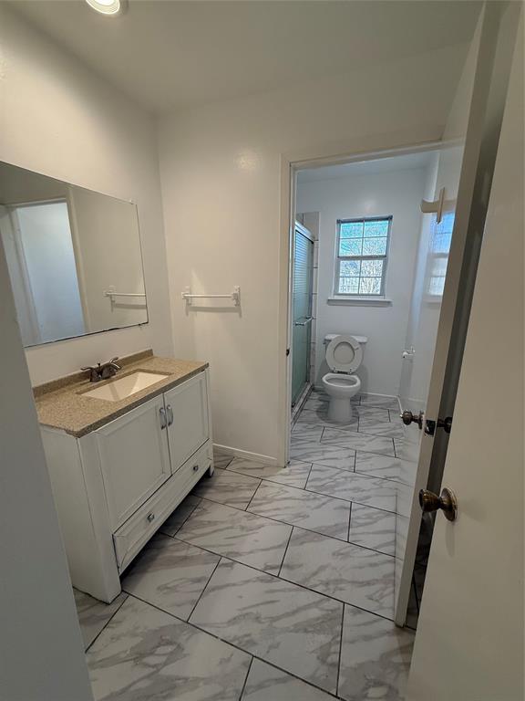 2529 Rutgers Drive Irving, TX 75062 - Photo 9 of 38 Bathroom featuring a white vanity with a light-toned countertop and an undermount sink