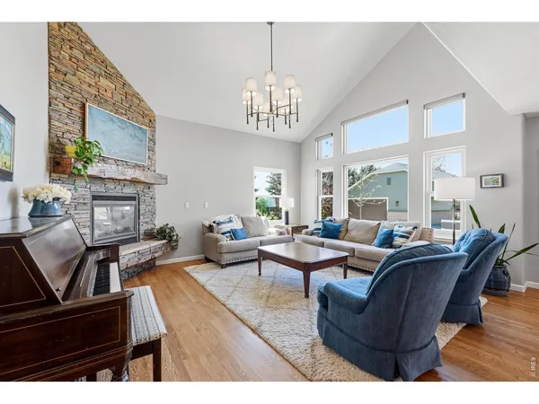 a living room with furniture a fireplace and a table