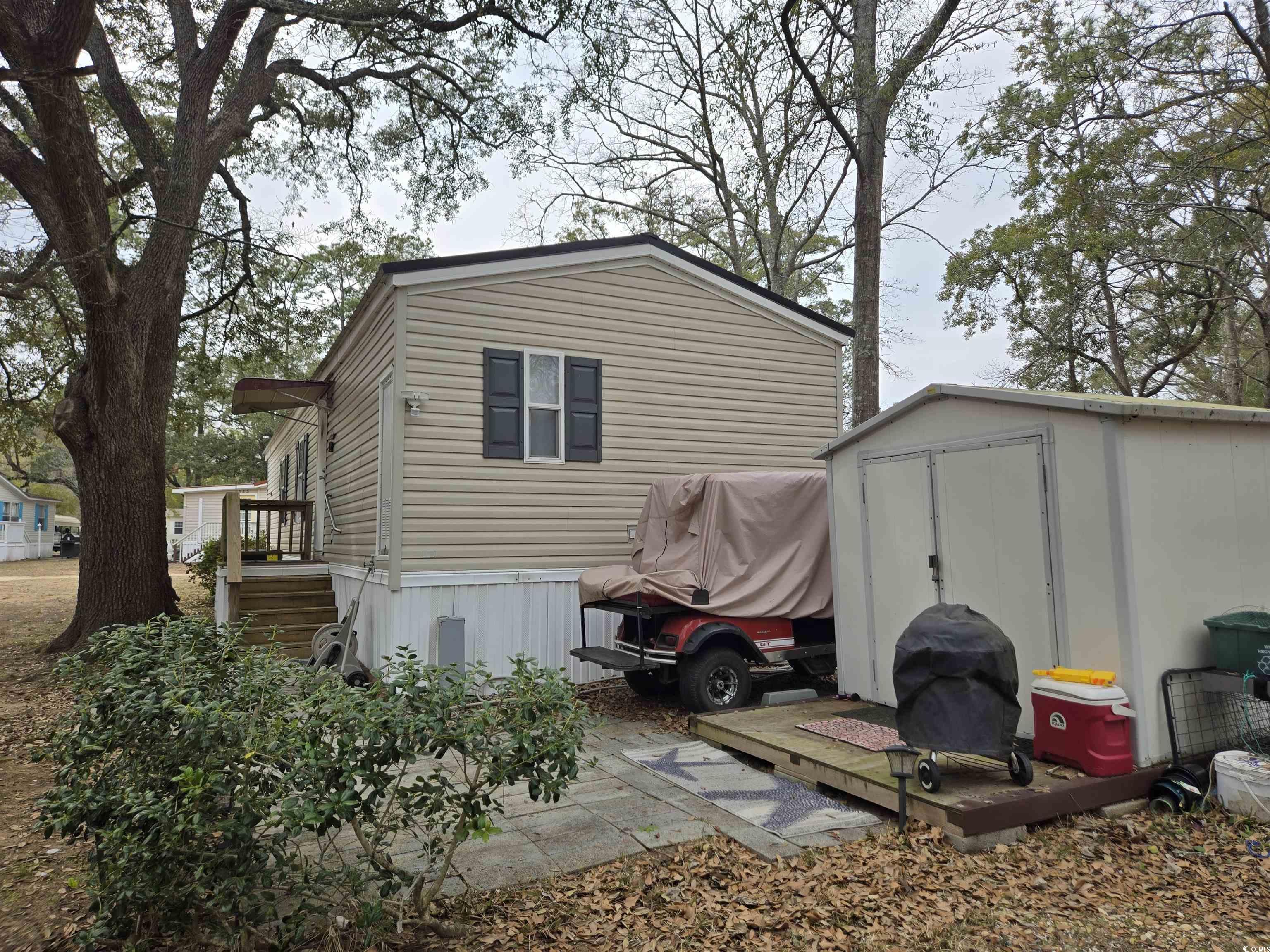 512 Porter Drive Murrells Inlet, SC 29576 - Photo 4 of 31 Exterior space featuring an outbuilding and a shed