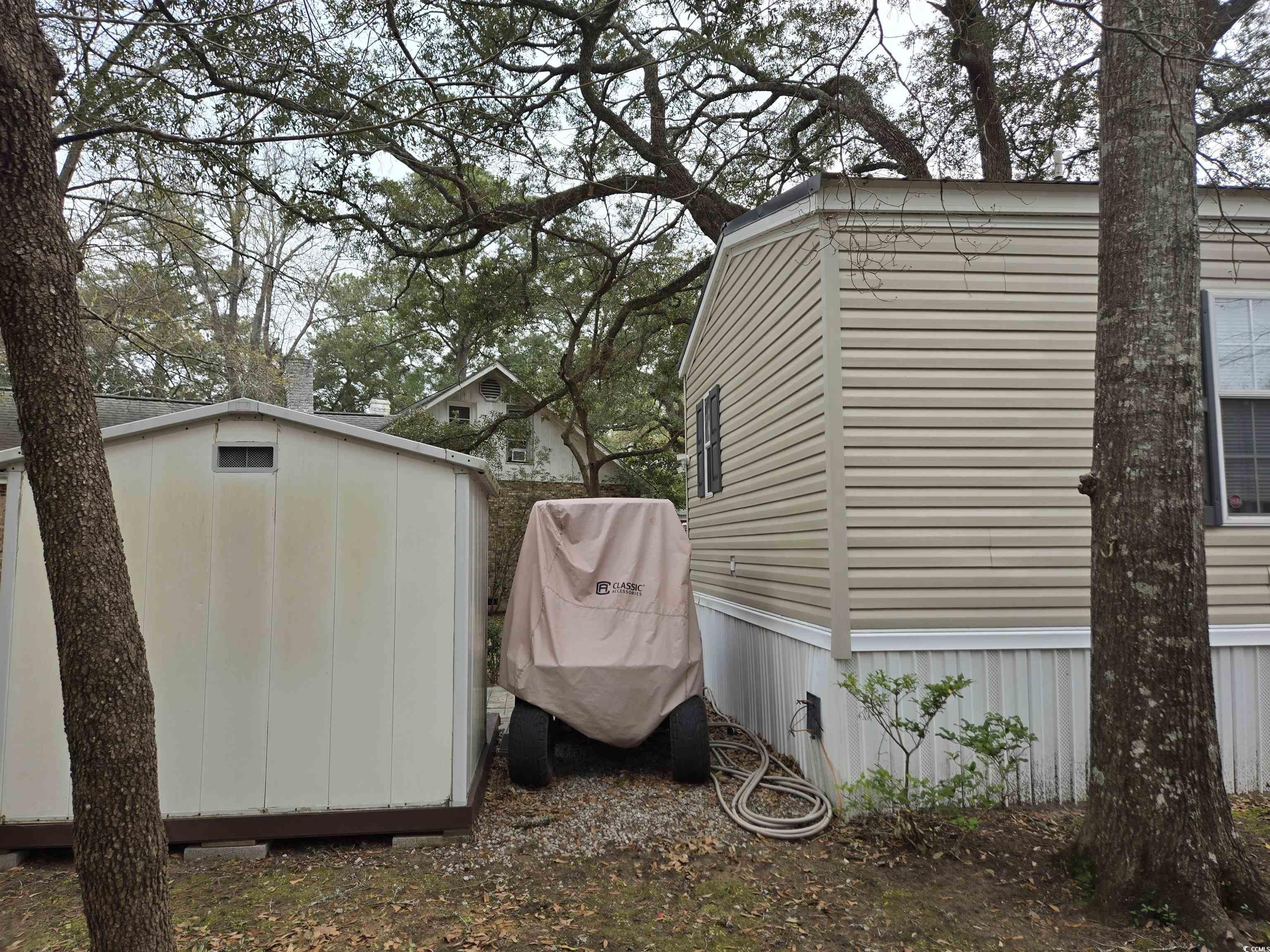 512 Porter Drive Murrells Inlet, SC 29576 - Photo 5 of 31 Exterior space featuring a storage unit and an out
