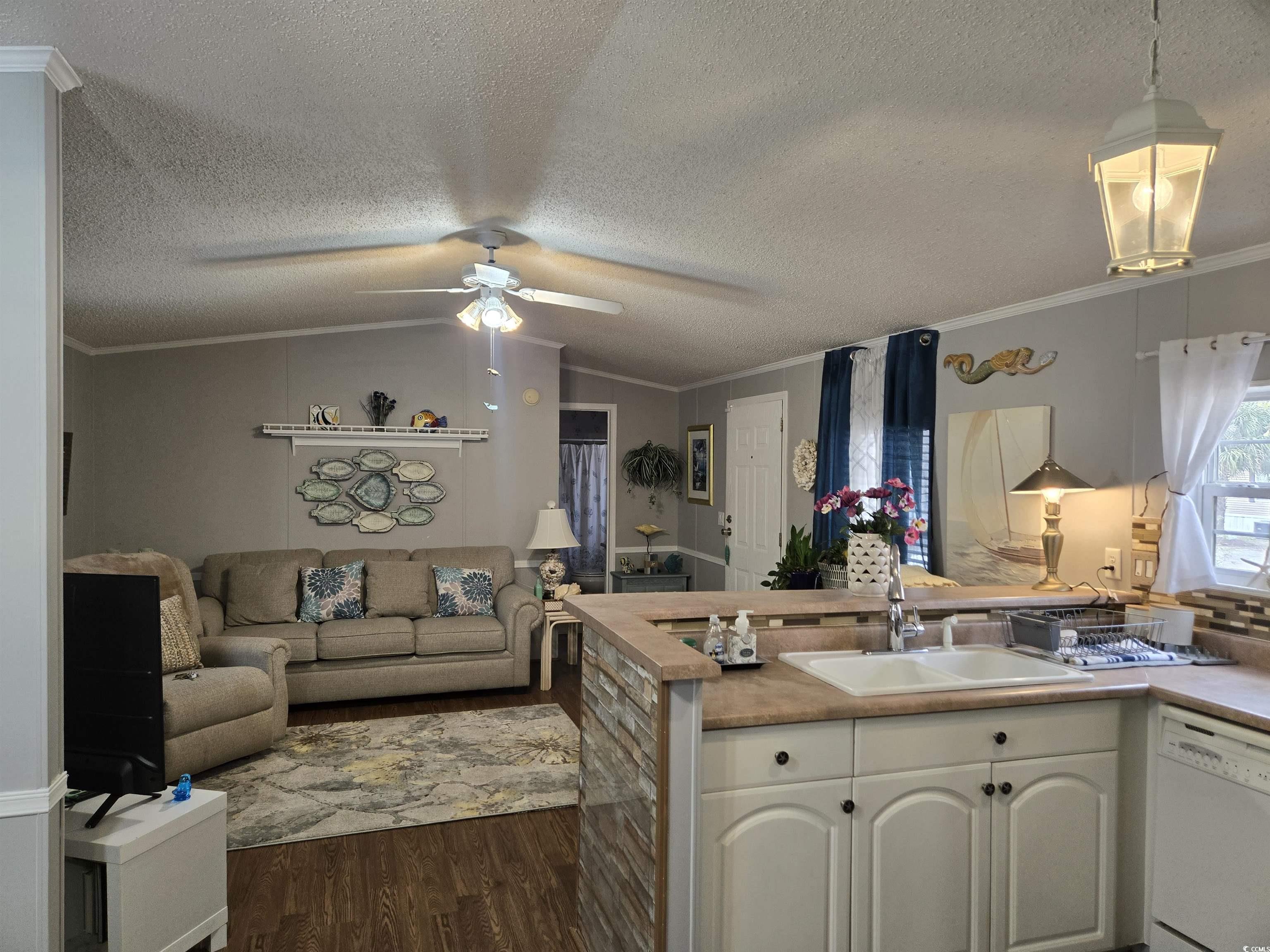 512 Porter Drive Murrells Inlet, SC 29576 - Photo 10 of 31 Kitchen featuring a ceiling fan, a sink, dark wood