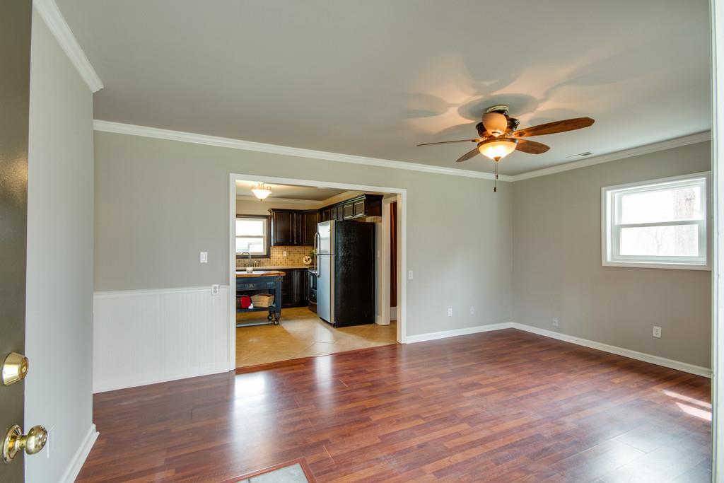 1020 Lambert Ridge Road Wartrace, TN 37183 - Photo 18 of 30 a view of a livingroom with wooden floor and a ceiling fan
