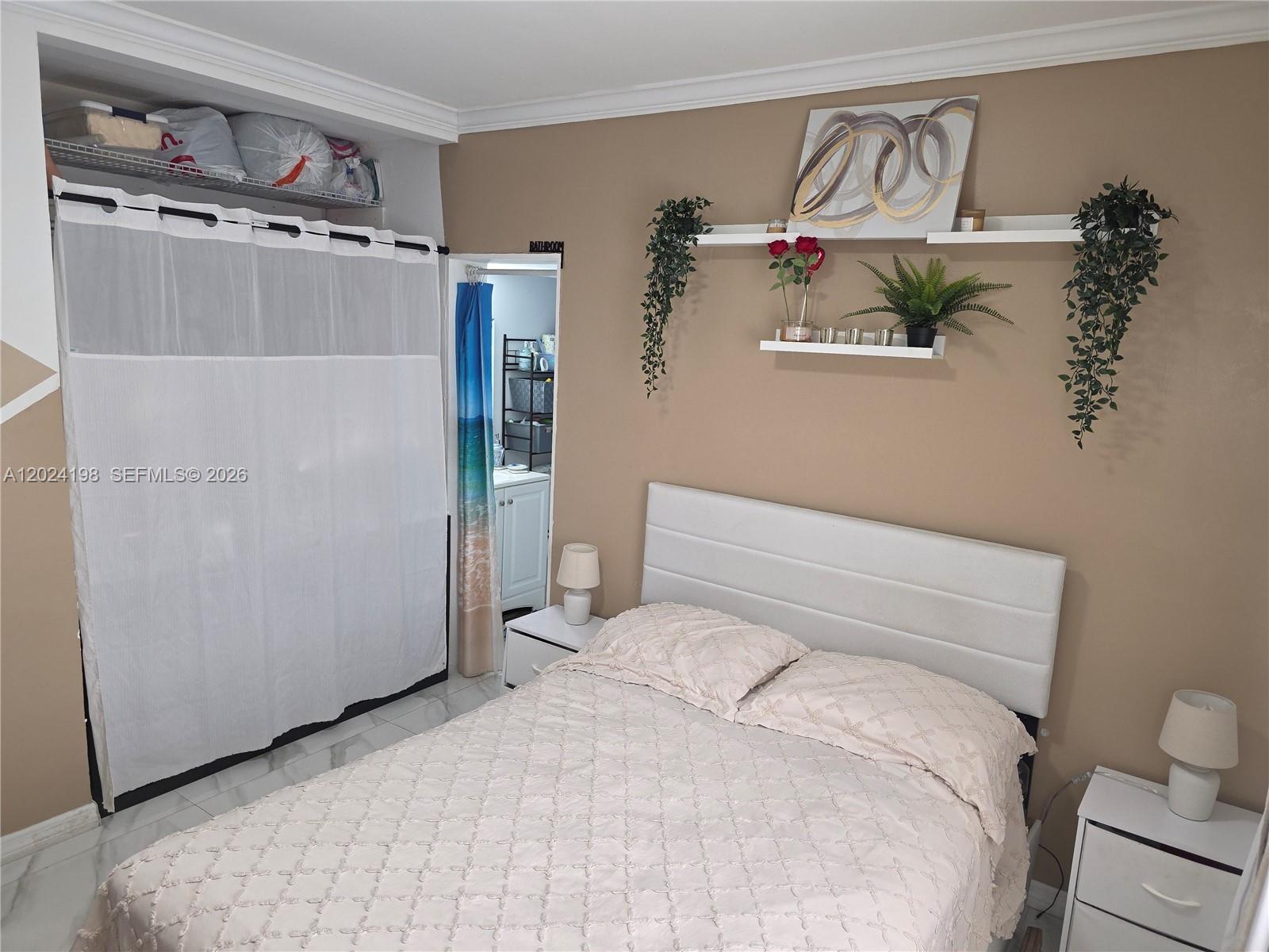 651 East 48th Street Hialeah, FL 33013 - Photo 12 of 52 a bedroom with a bed and a walk in closet