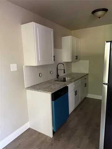 a kitchen with a sink stove and cabinets