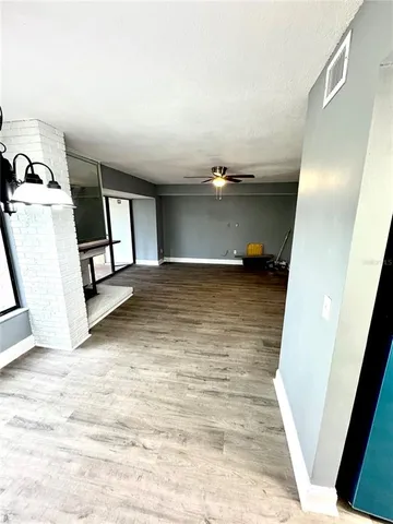 a view of a livingroom with wooden floor and staircase
