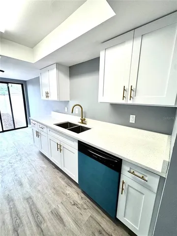 a kitchen with a sink cabinets and window