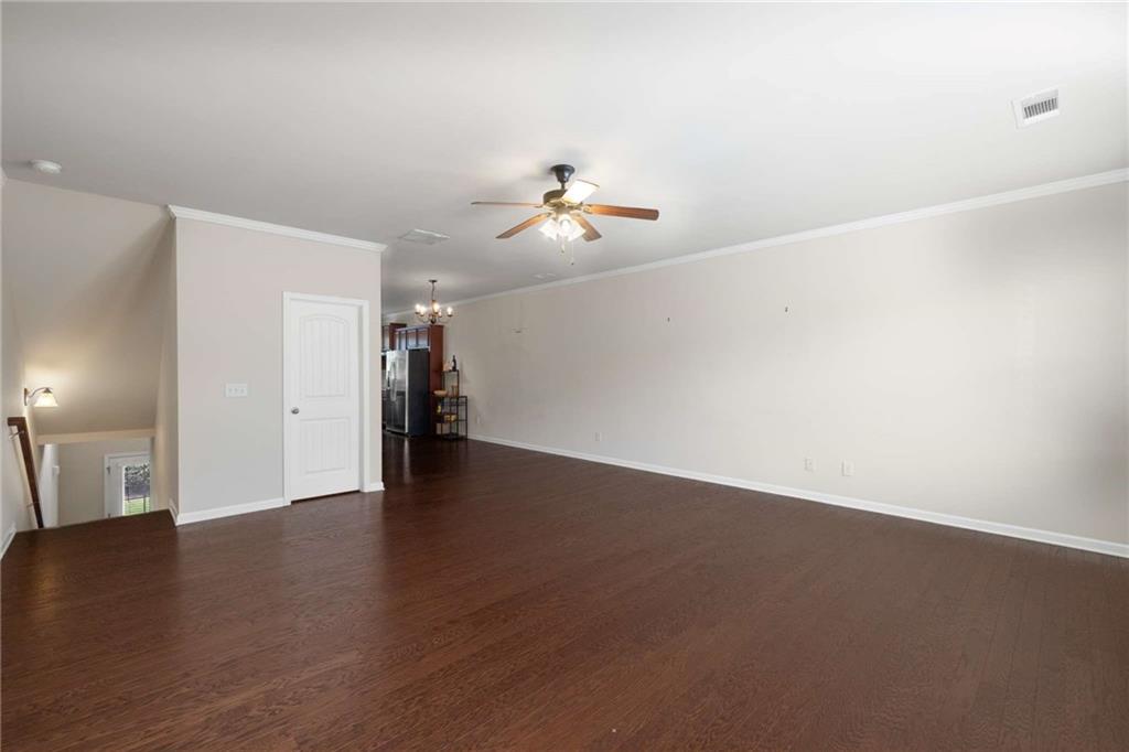 3084 Turman Circle Decatur, GA 30033 - Photo 4 of 36 a view of an empty room with wooden floor and a ceiling fan