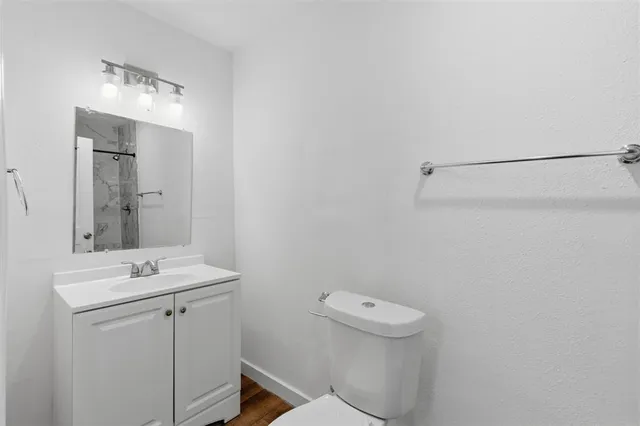 a bathroom with a sink a toilet and mirror