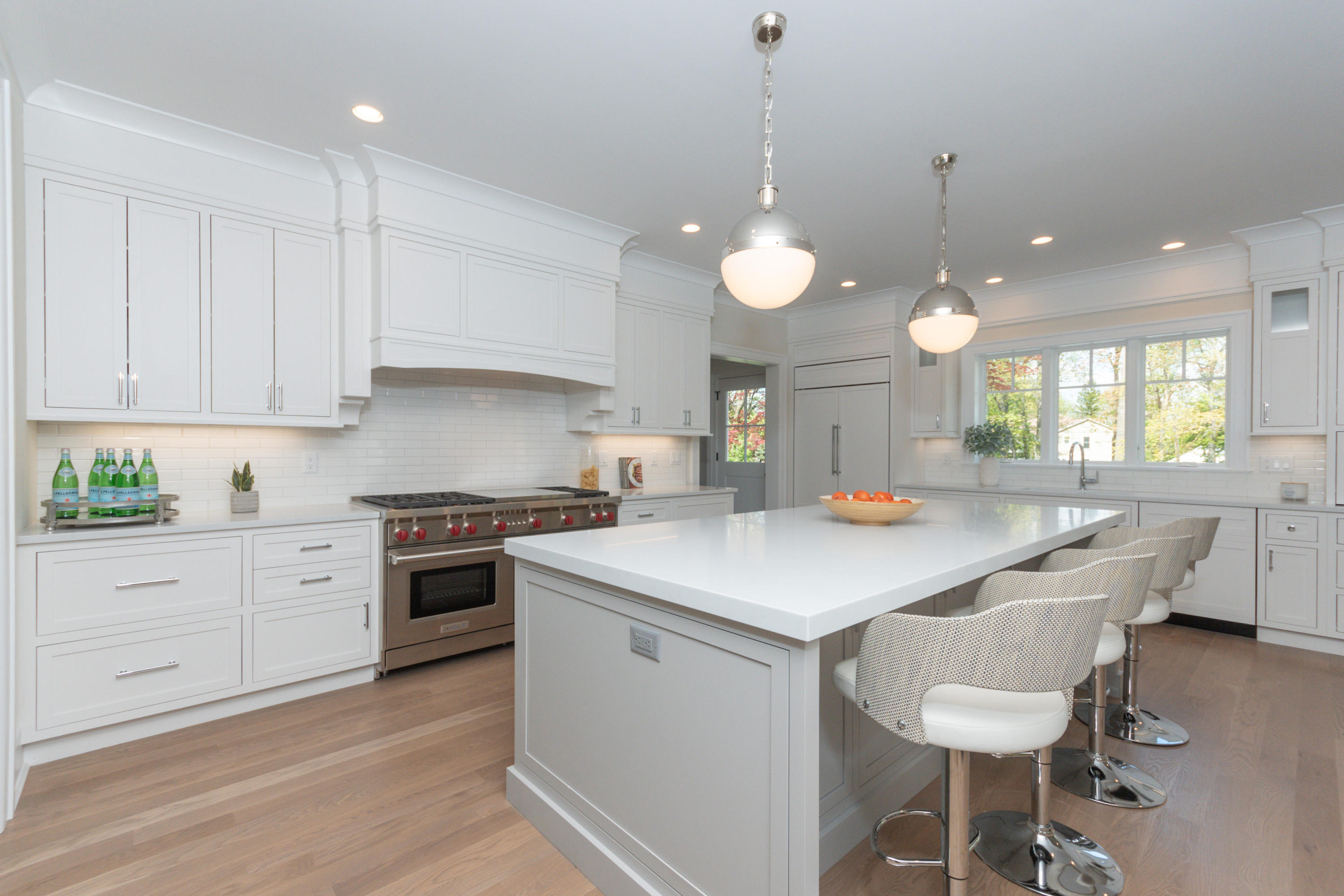 113 Hollow Tree Ridge Road Darien, CT 06820 - Photo 11 of 48 a kitchen with a stove a sink a dining table and chairs