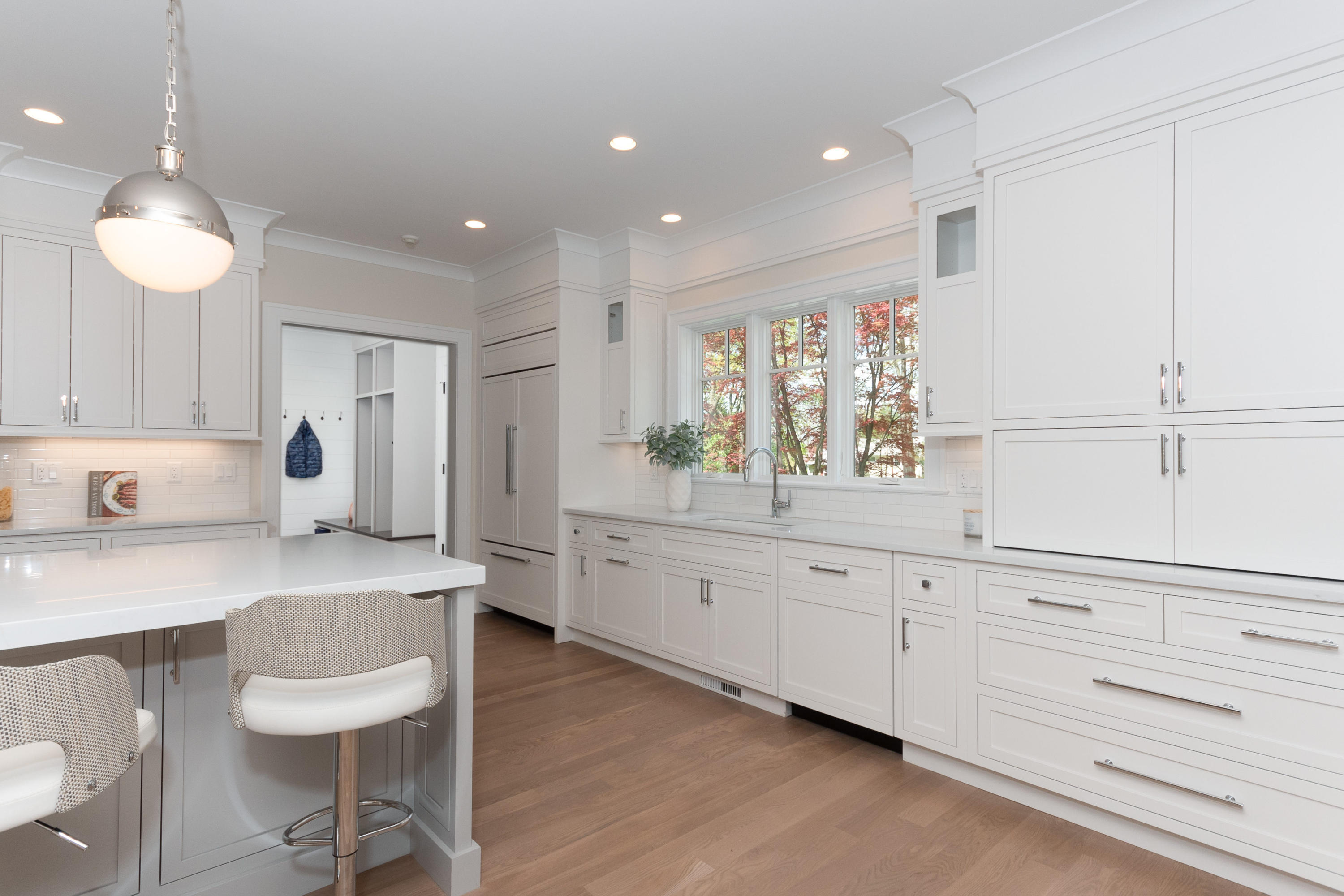 113 Hollow Tree Ridge Road Darien, CT 06820 - Photo 13 of 48 a kitchen with white cabinets and chairs