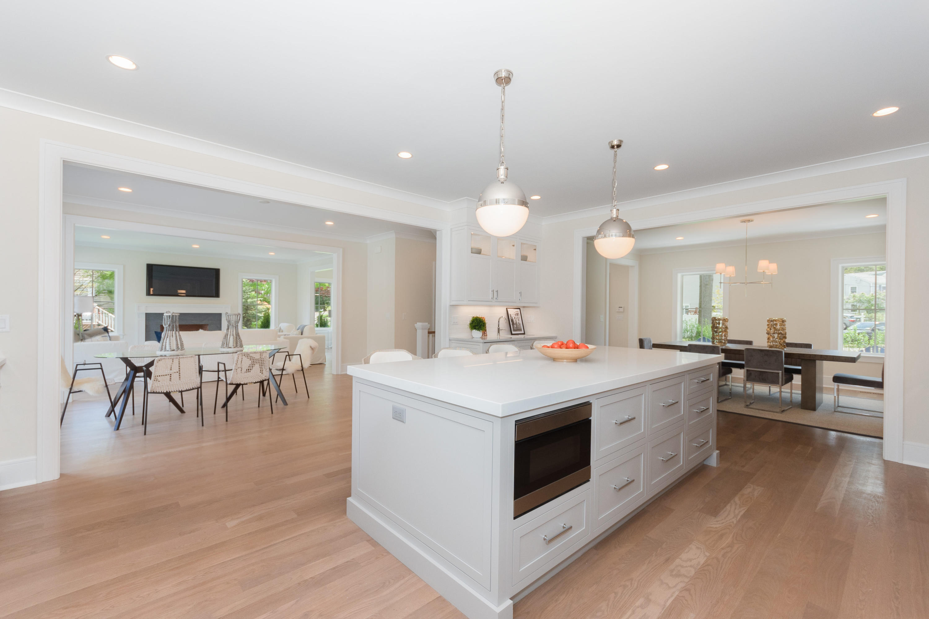 113 Hollow Tree Ridge Road Darien, CT 06820 - Photo 14 of 48 a large white kitchen with lots of counter space a sink appliances and living room view