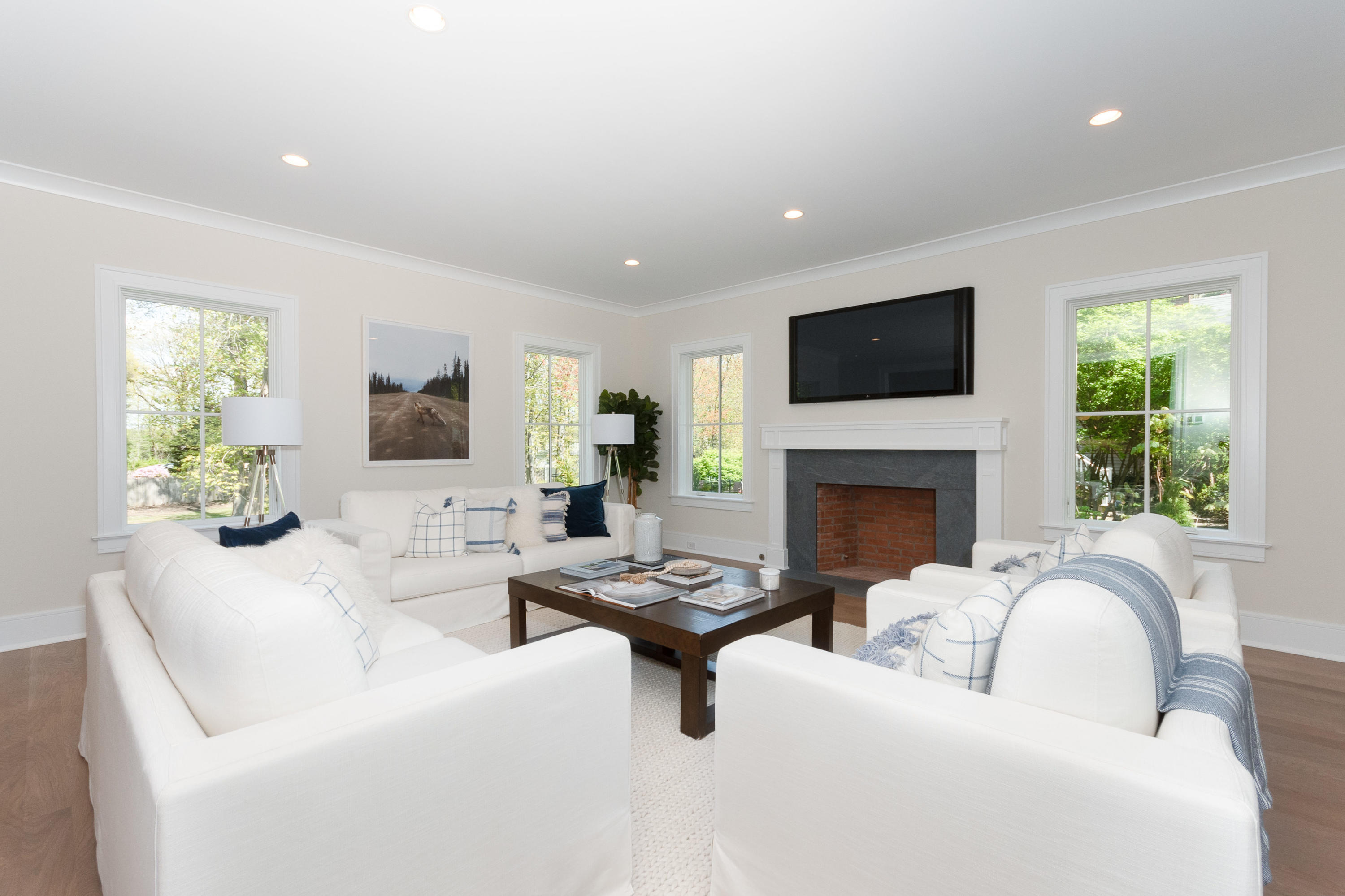 113 Hollow Tree Ridge Road Darien, CT 06820 - Photo 17 of 48 a living room with furniture a fireplace and a flat screen tv