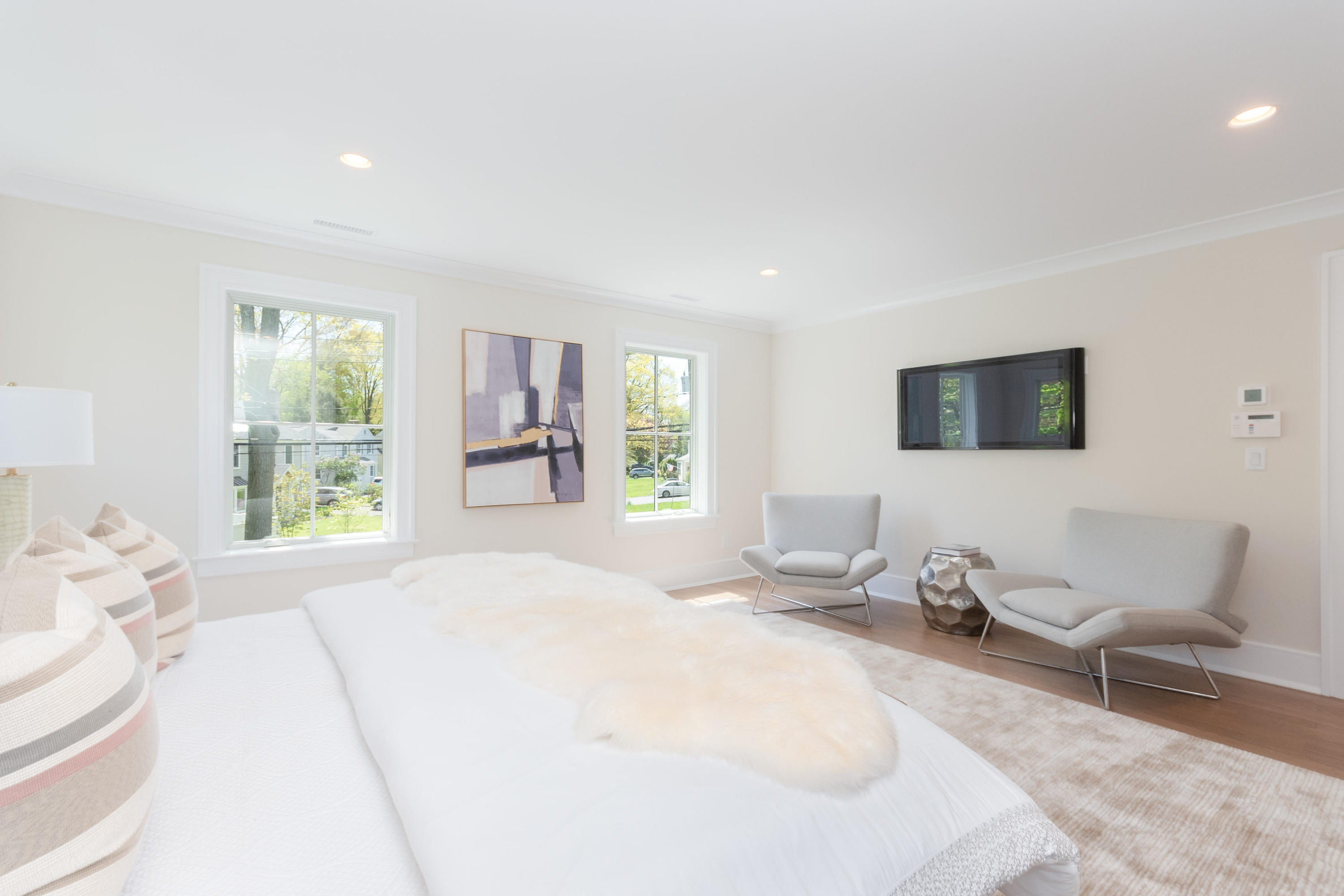 113 Hollow Tree Ridge Road Darien, CT 06820 - Photo 23 of 48 a bedroom with a bed and wooden floor