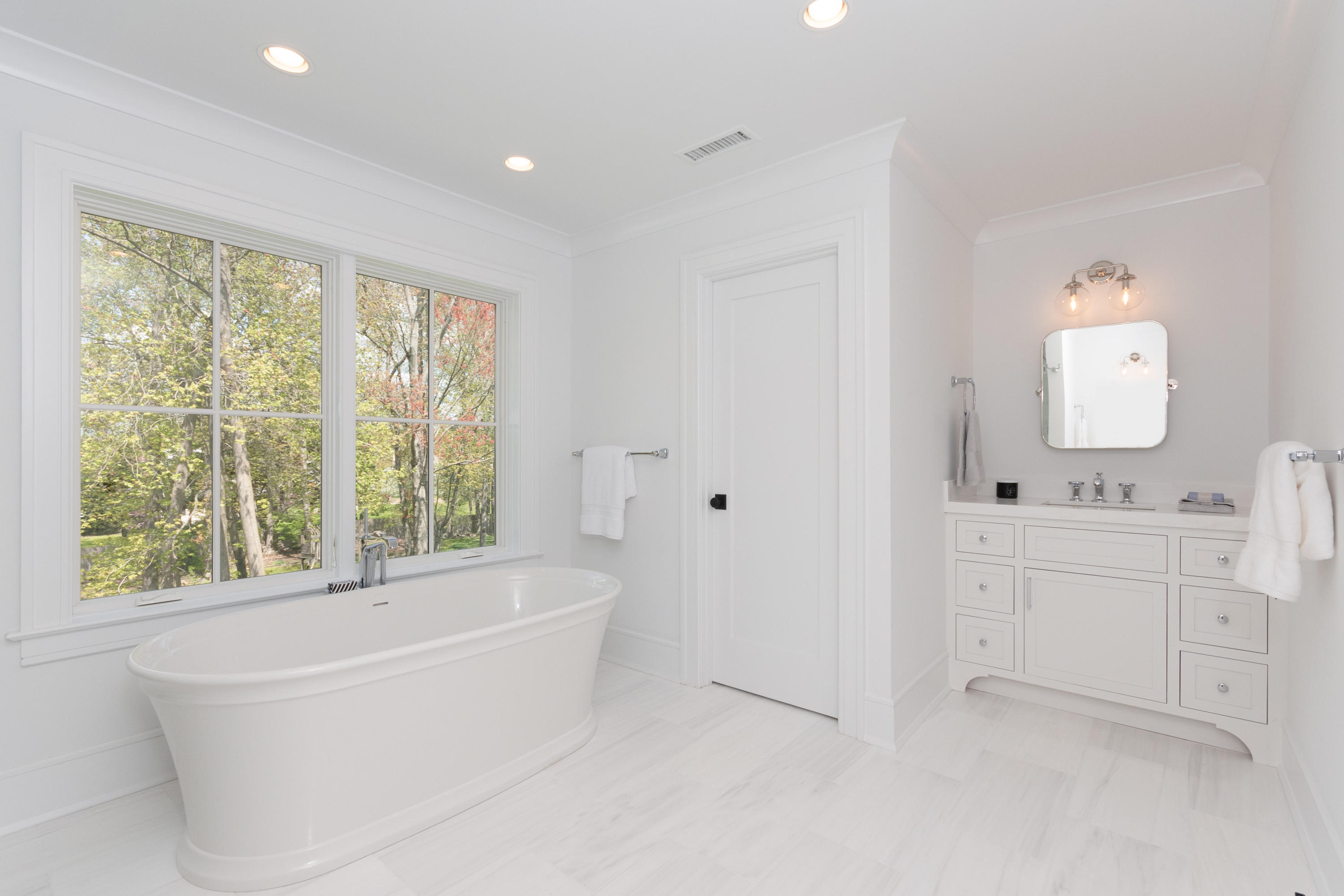 113 Hollow Tree Ridge Road Darien, CT 06820 - Photo 24 of 48 a bathroom with white cabinets and a bathtub
