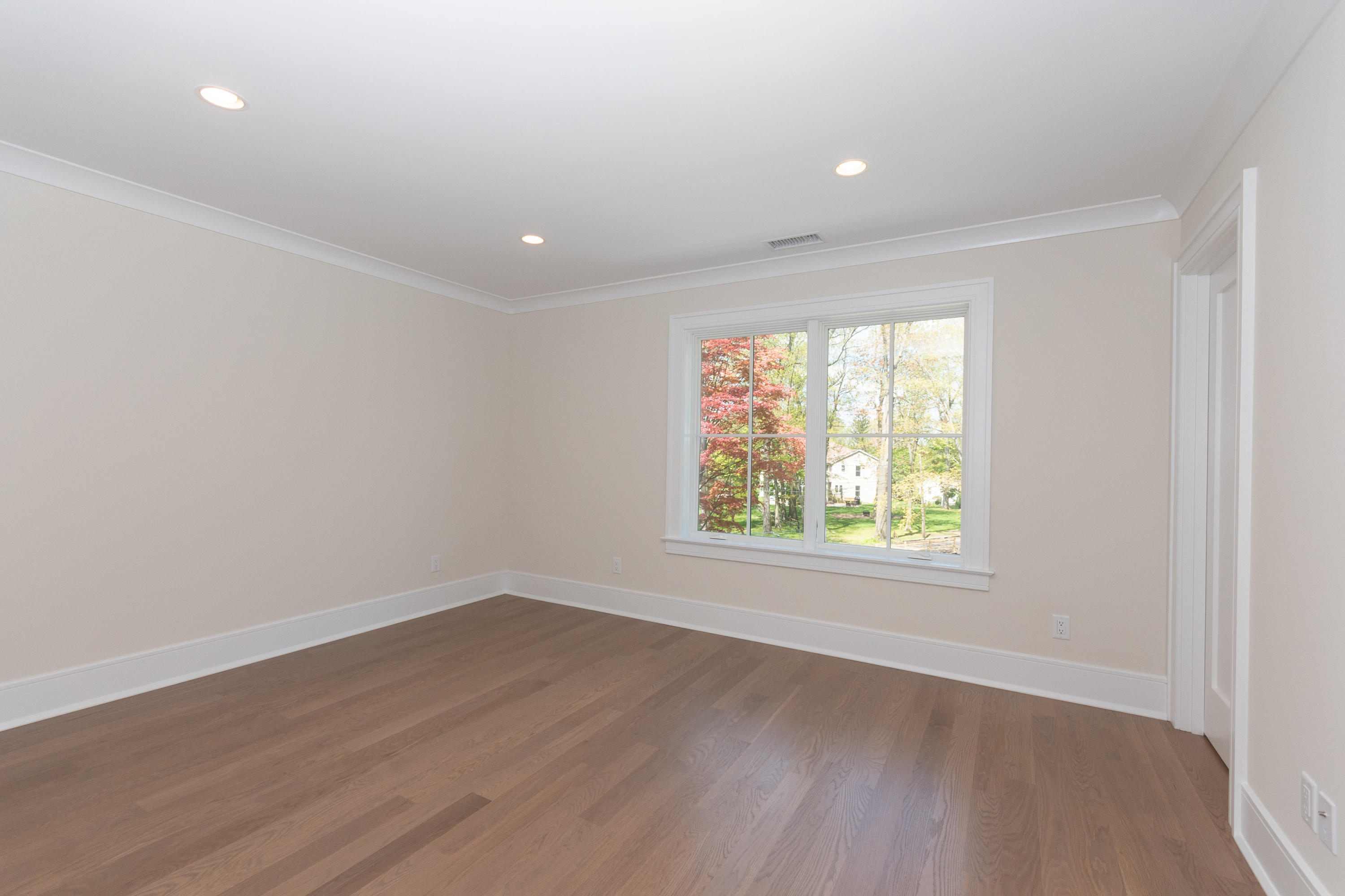 113 Hollow Tree Ridge Road Darien, CT 06820 - Photo 26 of 48 an empty room with wooden floor and windows