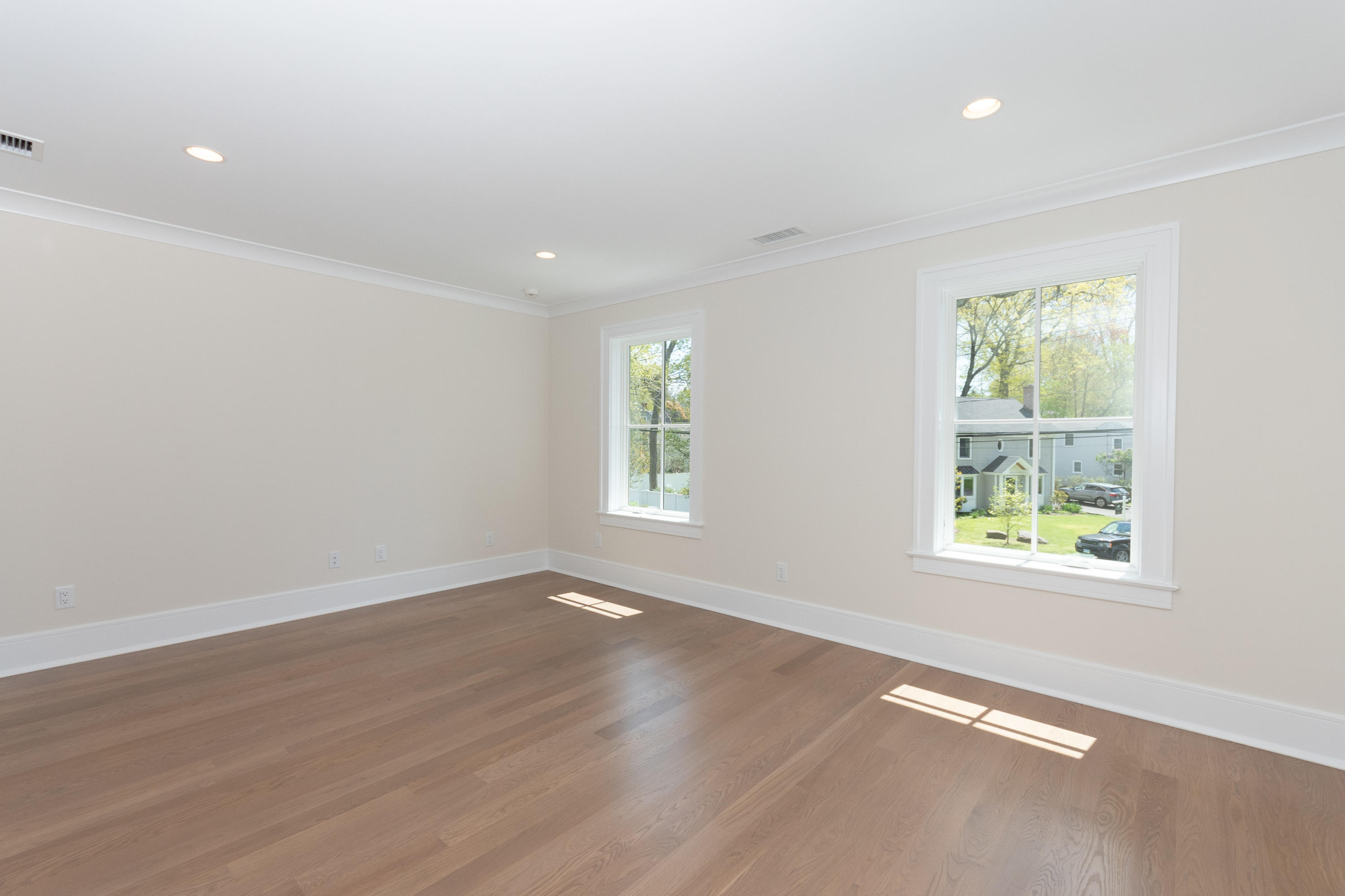 113 Hollow Tree Ridge Road Darien, CT 06820 - Photo 27 of 48 an empty room with wooden floor and windows