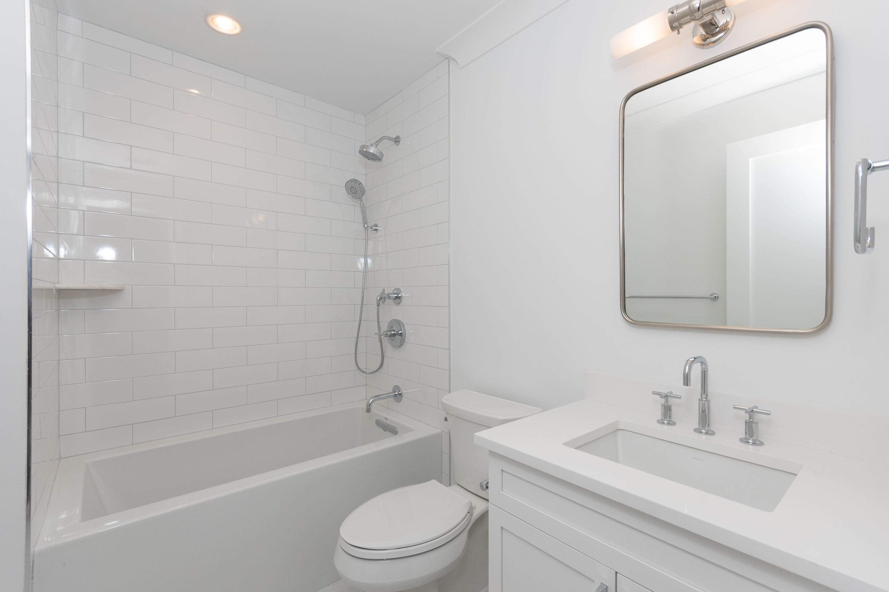 113 Hollow Tree Ridge Road Darien, CT 06820 - Photo 28 of 48 a bathroom with a toilet a sink a mirror a bathtub and vanity