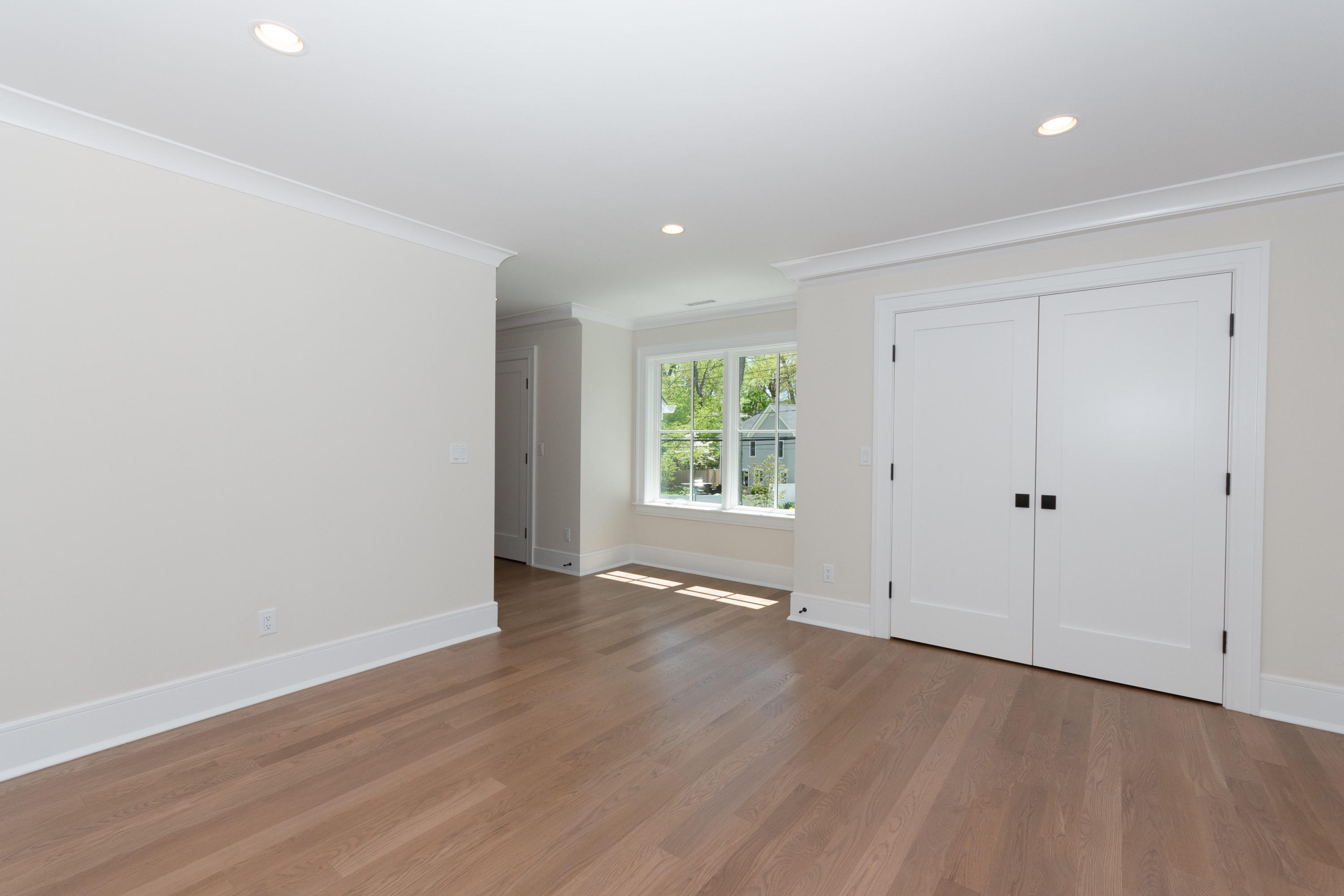 113 Hollow Tree Ridge Road Darien, CT 06820 - Photo 29 of 48 a view of an empty room with wooden floor and a window