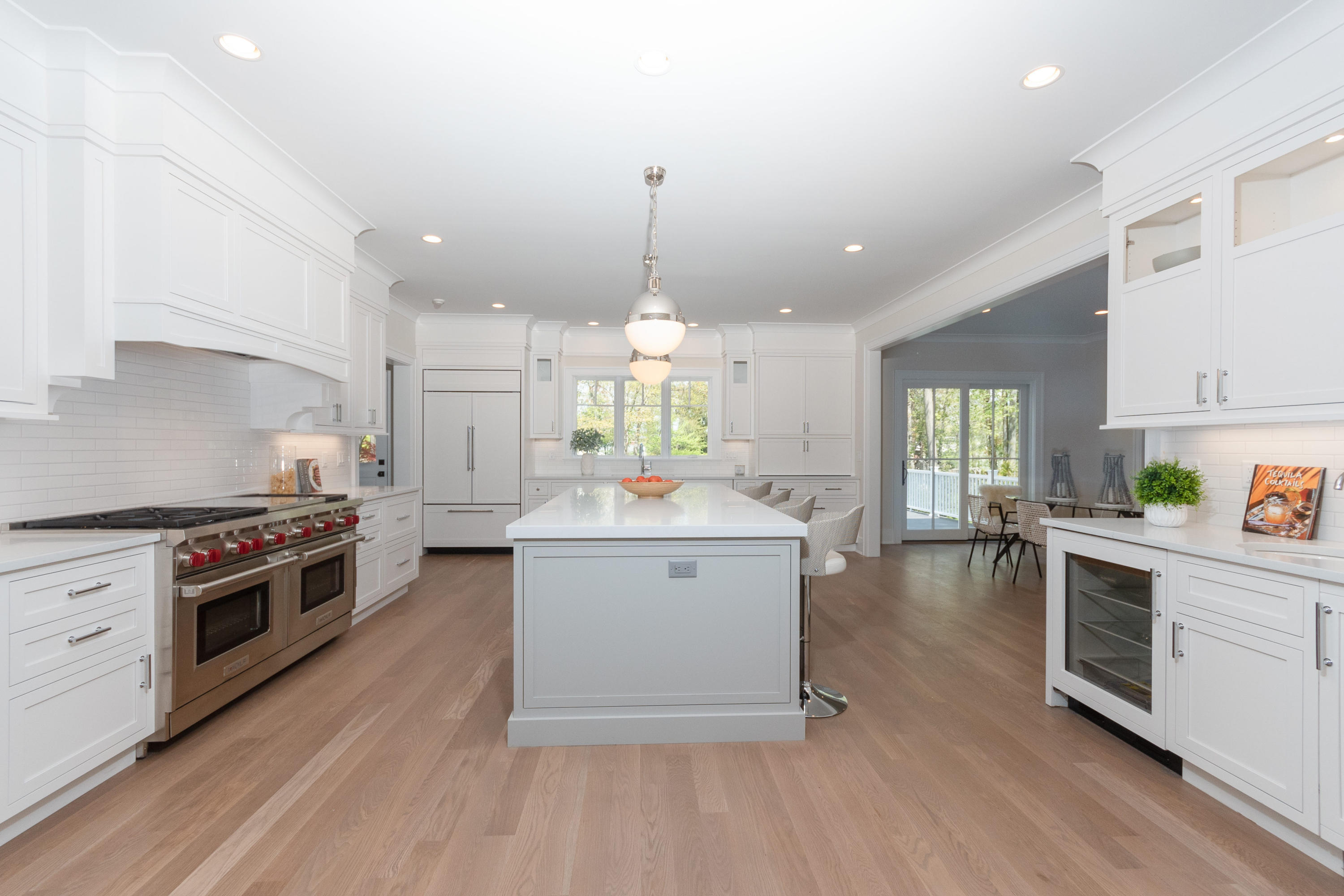 113 Hollow Tree Ridge Road Darien, CT 06820 - Photo 10 of 48 a large kitchen with granite countertop a stove top oven a sink a dining table and chairs with wooden floor