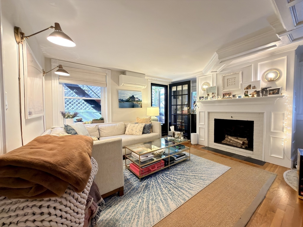 41 Pinckney Street, Unit B Boston, MA 02114 - Photo 20 of 31 a living room with furniture and a fireplace
