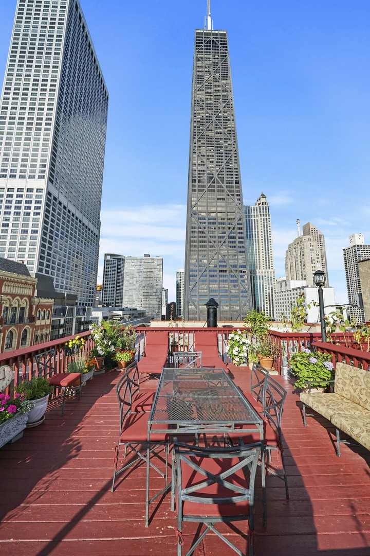 222 East Chestnut Street, Unit 8A Chicago, IL 60611 - Photo 29 of 41 a view of a balcony with two chairs and a table