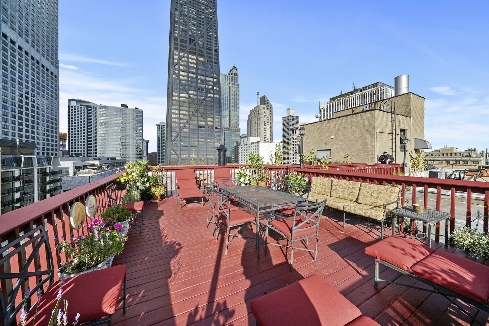 222 East Chestnut Street, Unit 8A Chicago, IL 60611 - Photo 30 of 41 a balcony with wooden floor table and chairs