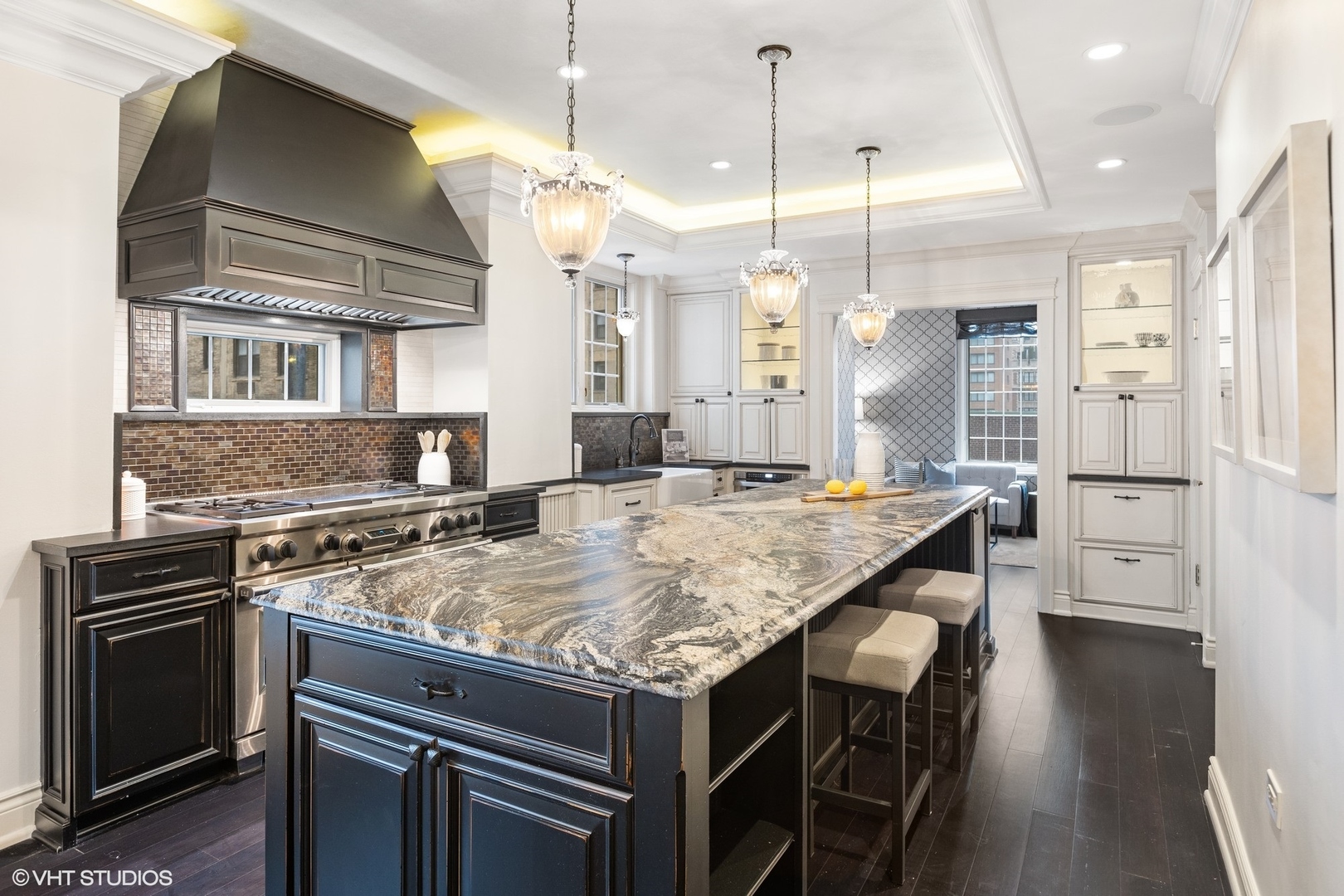 222 East Chestnut Street, Unit 8A Chicago, IL 60611 - Photo 9 of 41 a kitchen with center island wooden floor and stainless steel appliances