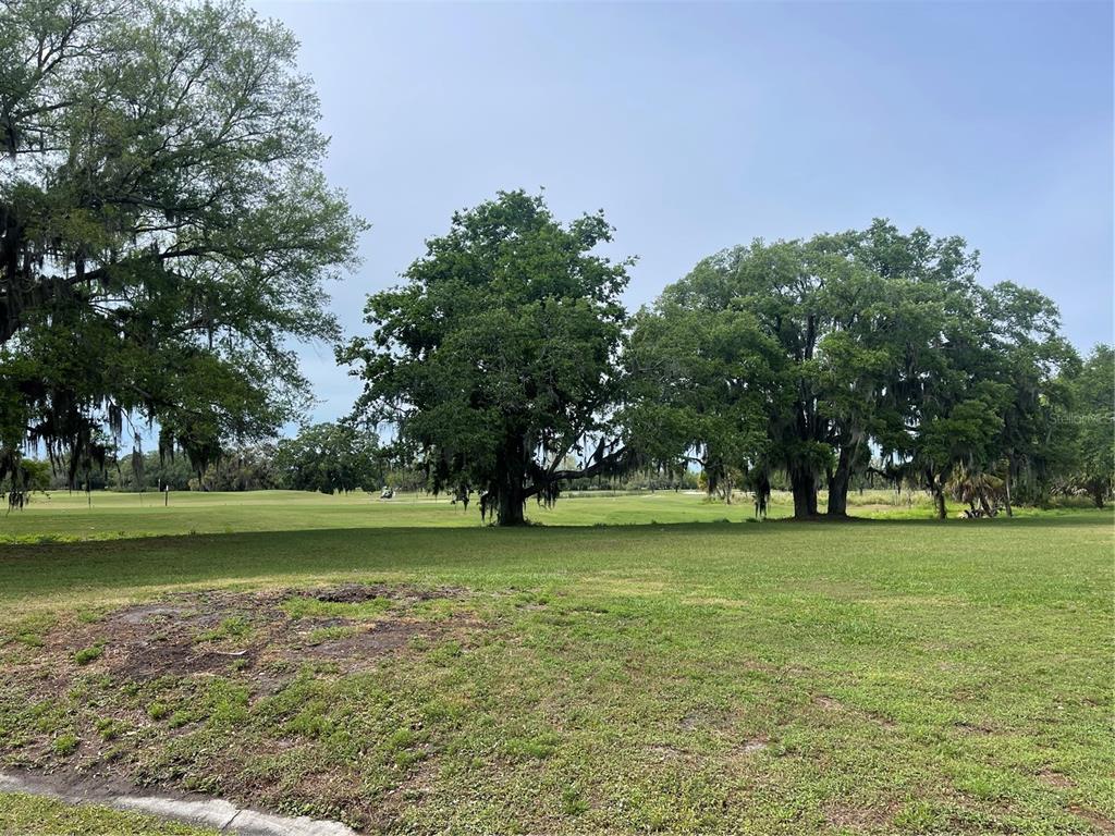 335 Bobby Jones Road, Unit 335 Sarasota, FL 34232 - Photo 15 of 16 a view of a field with trees in the background