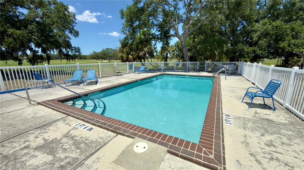 335 Bobby Jones Road, Unit 335 Sarasota, FL 34232 - Photo 16 of 16 a view of a swimming pool with a lounge chairs