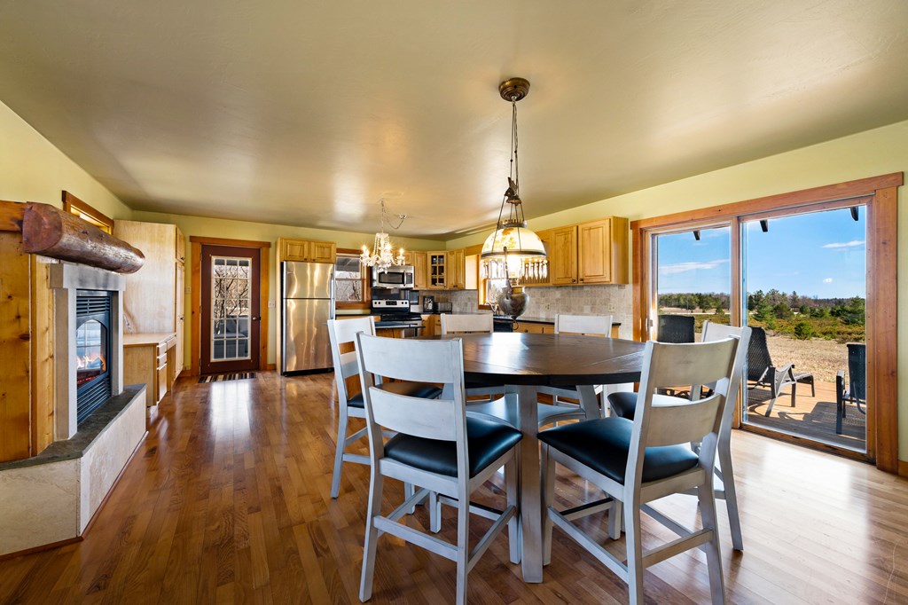 12071 County Rd NP Ellison Bay, WI 54210 - Photo 10 of 40 Dining Area with Gas Fireplace