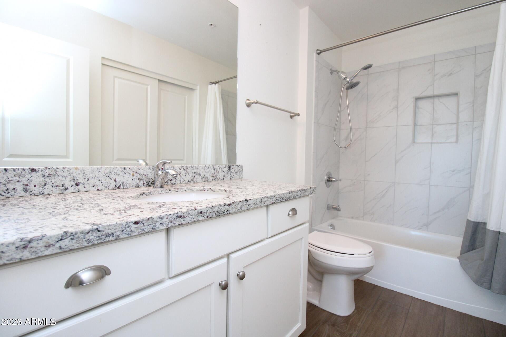 2511 West Queen Creek Road, Unit 438 Chandler, AZ 85248 - Photo 13 of 23 a bathroom with a granite countertop sink toilet and shower