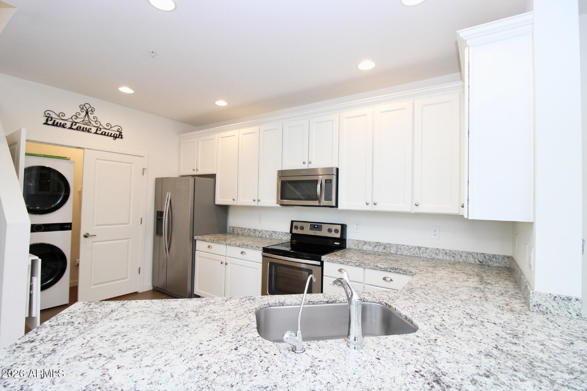 2511 West Queen Creek Road, Unit 438 Chandler, AZ 85248 - Photo 2 of 23 a kitchen with a refrigerator sink and stove