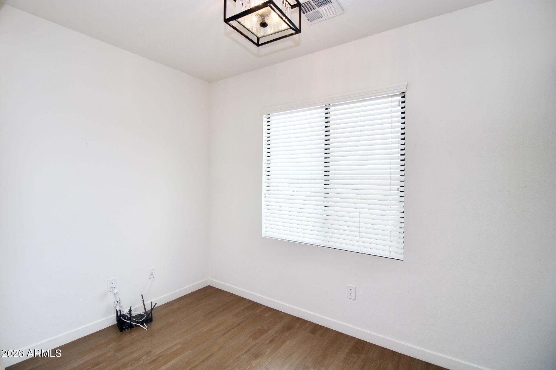 2511 West Queen Creek Road, Unit 438 Chandler, AZ 85248 - Photo 5 of 23 an empty room with a window