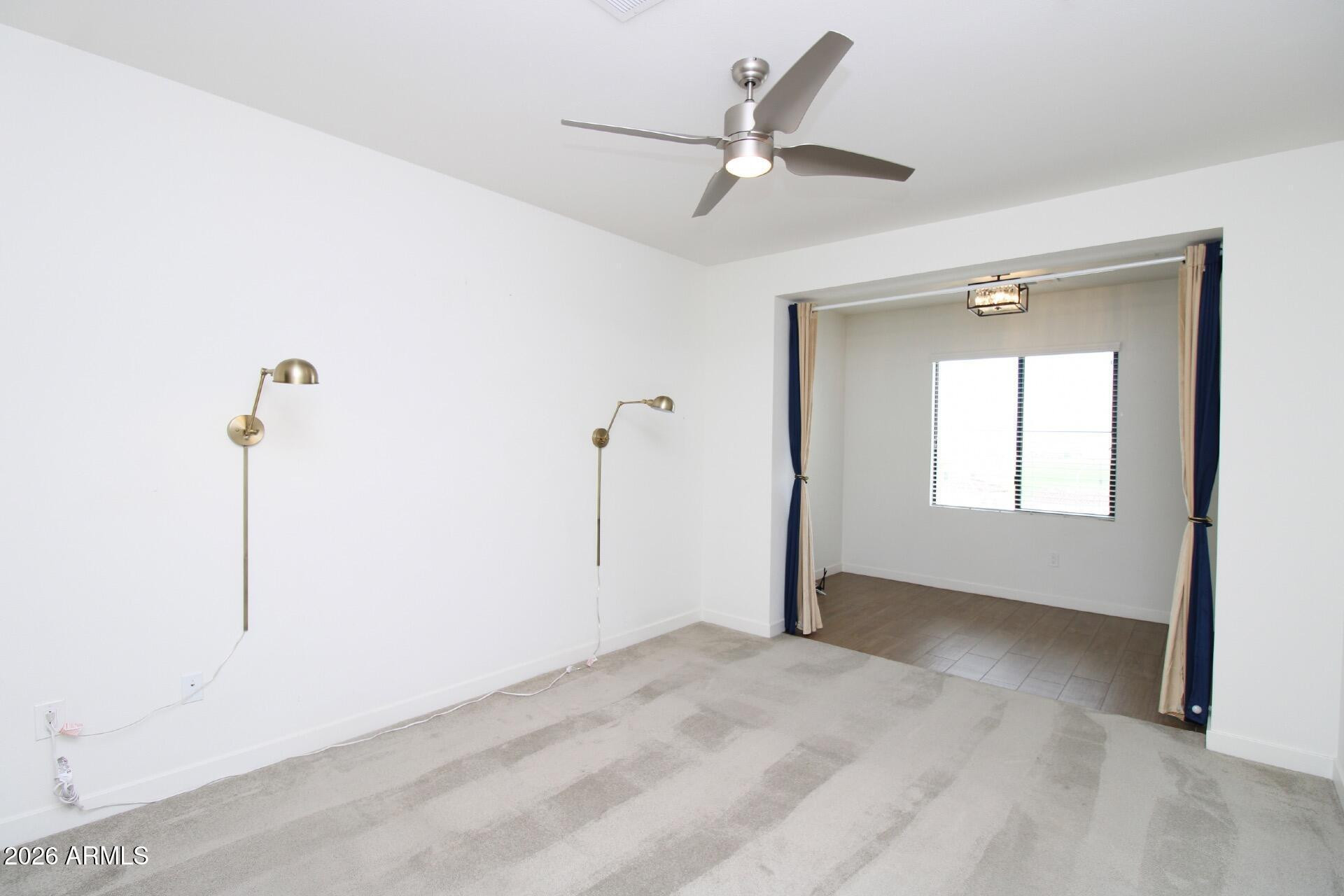 2511 West Queen Creek Road, Unit 438 Chandler, AZ 85248 - Photo 7 of 23 a view of a livingroom with a ceiling fan and window