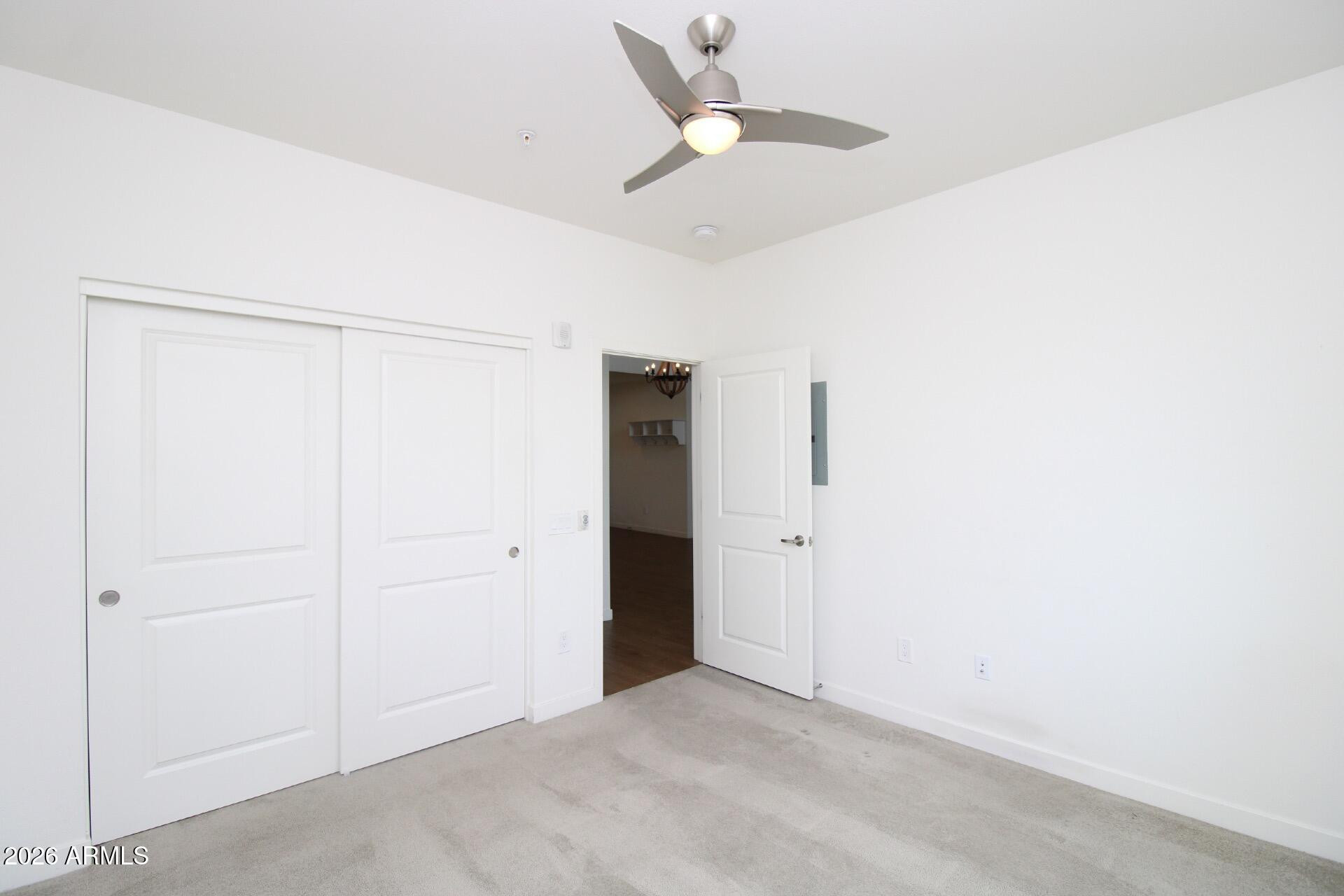 2511 West Queen Creek Road, Unit 438 Chandler, AZ 85248 - Photo 8 of 23 an empty room with a ceiling fan and a window