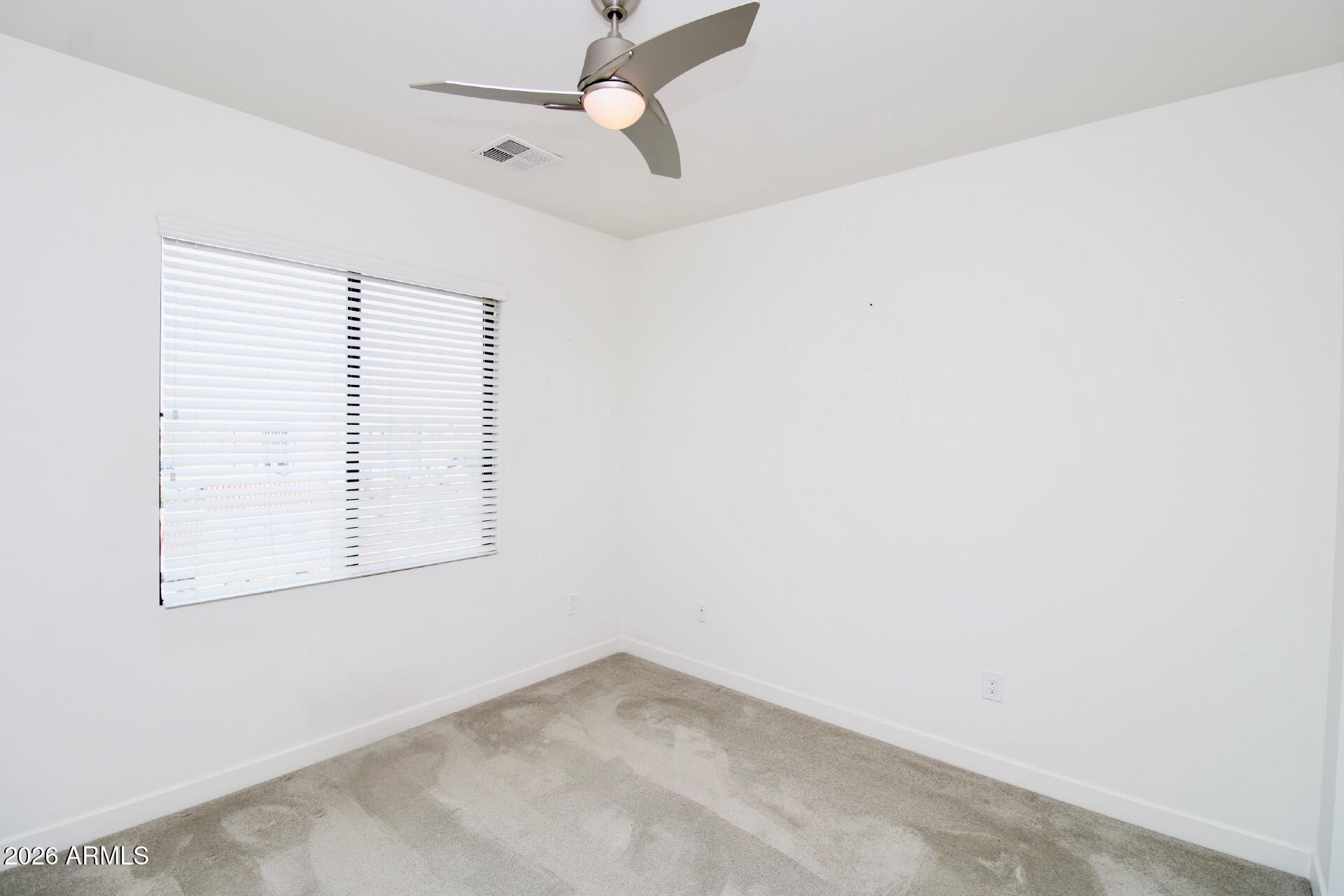 2511 West Queen Creek Road, Unit 438 Chandler, AZ 85248 - Photo 9 of 23 an empty room with a window and a fan