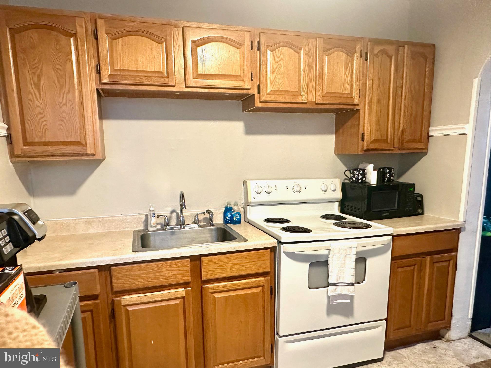 3413 Penn Avenue Sinking Spring, PA 19608 - Photo 5 of 17 a kitchen with stainless steel appliances granite countertop a sink and cabinets