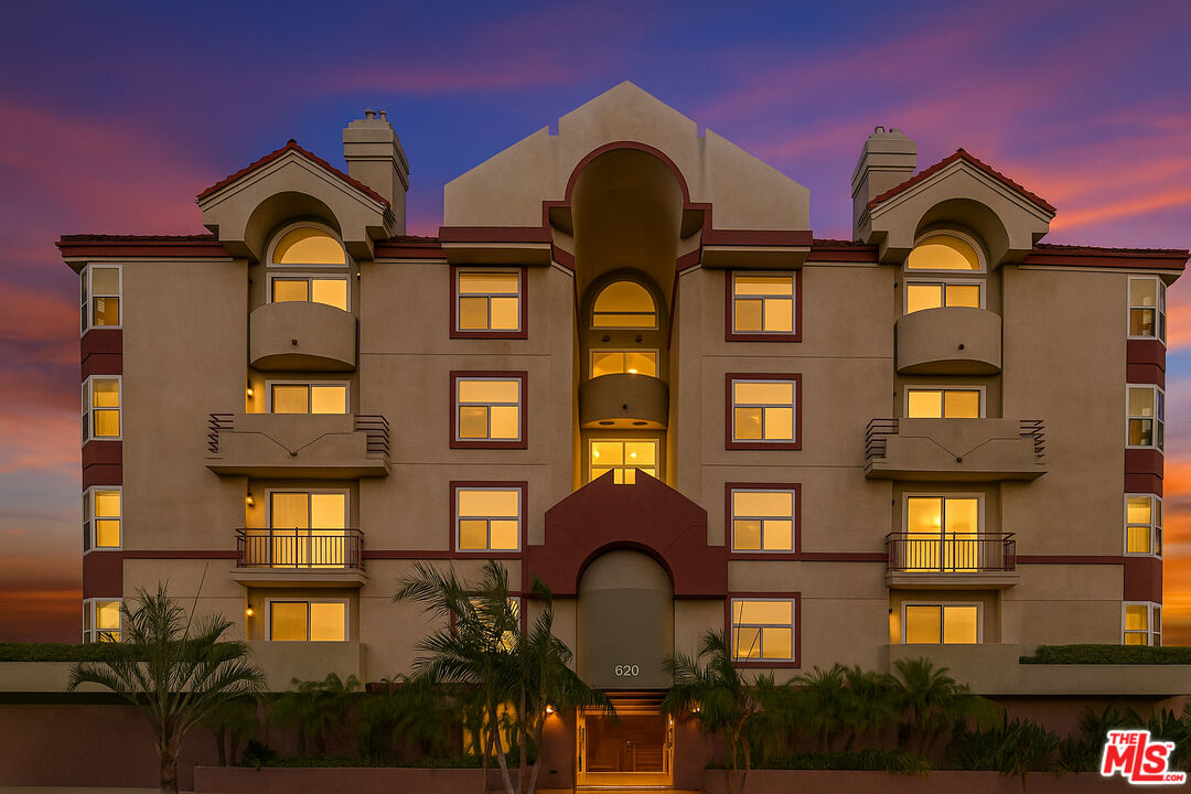 620 South Gramercy Place, Unit 135 Los Angeles, CA 90010 - Photo 1 of 1 a front view of a residential apartment building with a yard