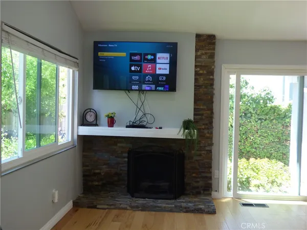a living room with fireplace and a large window