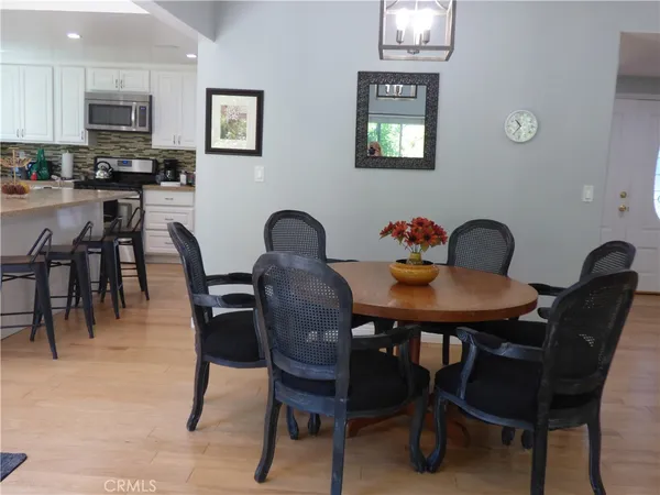 a view of a dining room with furniture and chandelier