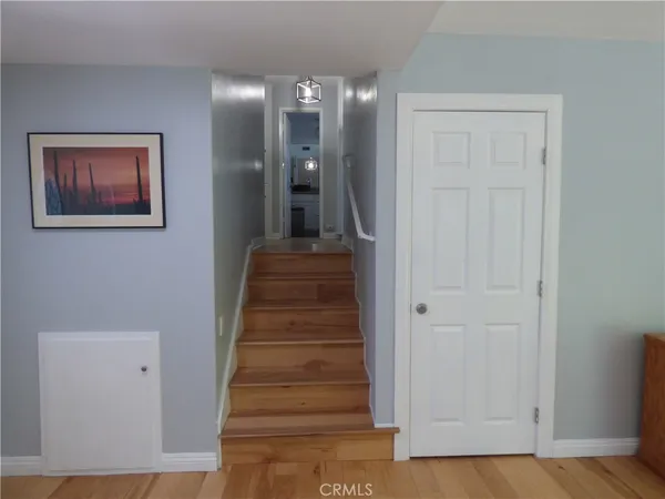 a view of a hallway with staircase and white walls