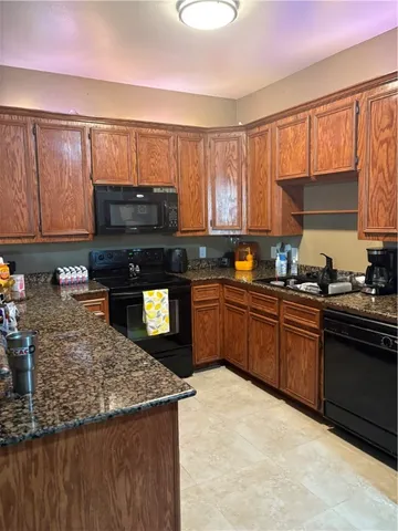 a kitchen with a sink a stove and cabinets