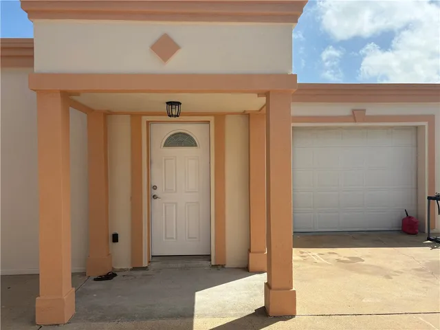 an entrance to house with yard