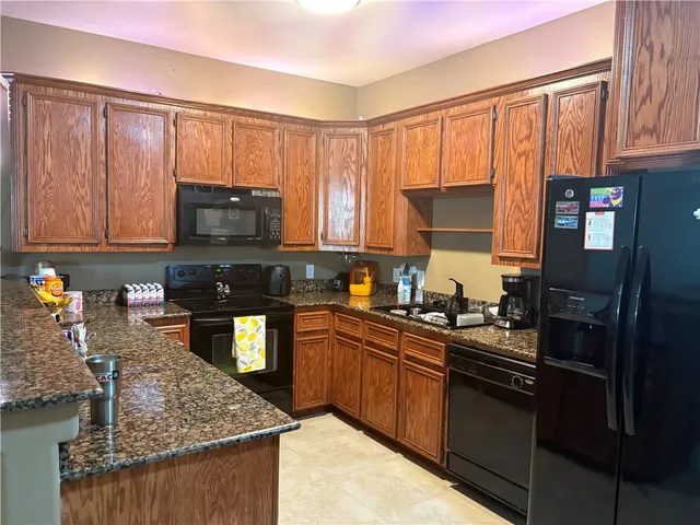 a kitchen with a sink stove and microwave