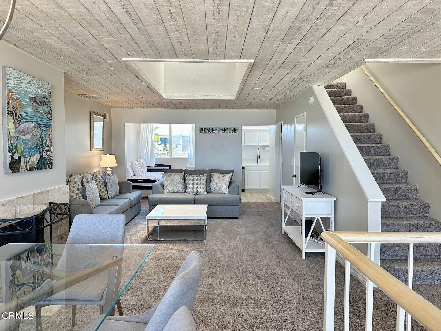 1364 Neptune Square Oxnard, CA 93035 - Photo 17 of 42 a living room with furniture and a chandelier
