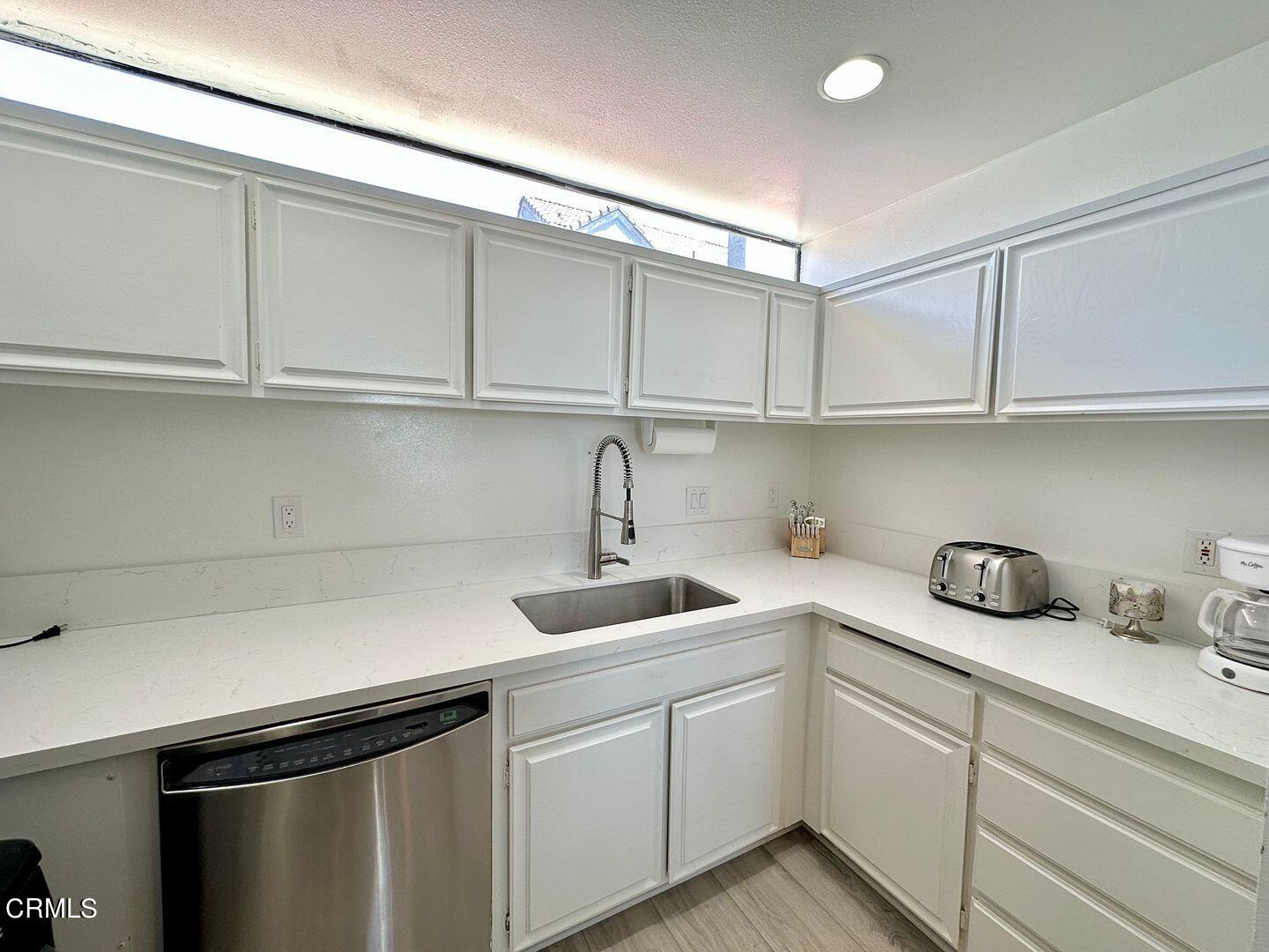 1364 Neptune Square Oxnard, CA 93035 - Photo 19 of 42 a kitchen with stainless steel appliances granite countertop a sink and cabinets