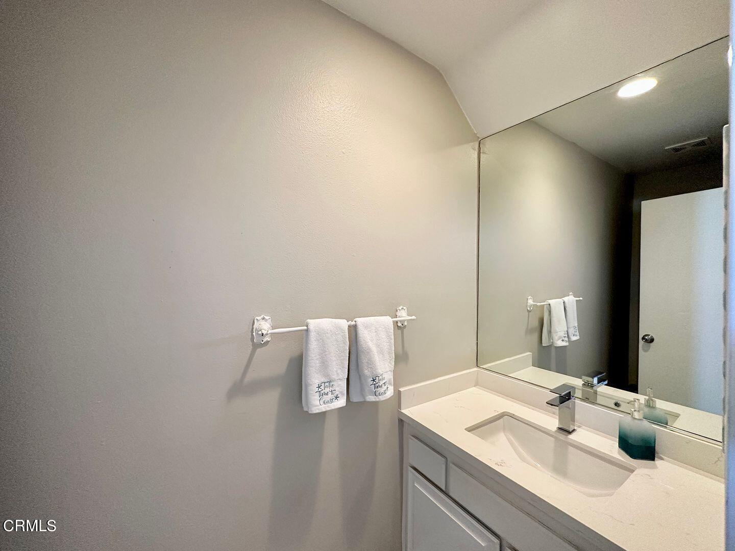1364 Neptune Square Oxnard, CA 93035 - Photo 24 of 42 a bathroom with a sink vanity and mirror