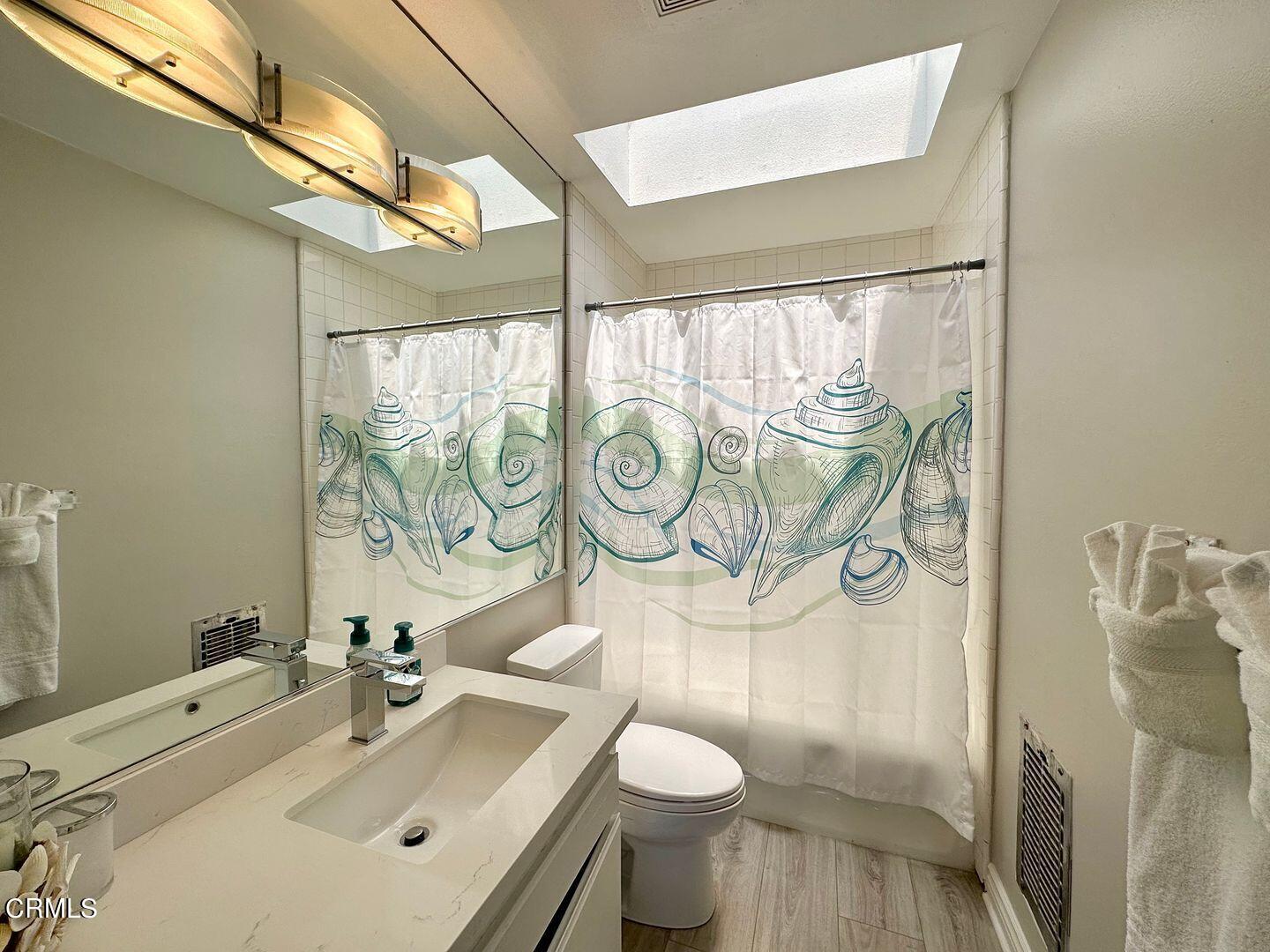 1364 Neptune Square Oxnard, CA 93035 - Photo 30 of 42 a bathroom with a sink mirror vanity and toilet