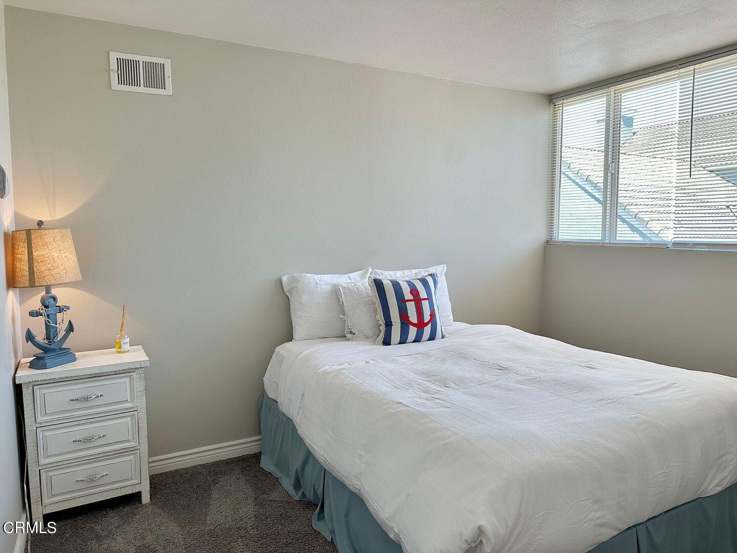 1364 Neptune Square Oxnard, CA 93035 - Photo 31 of 42 a bedroom with a bed and a dresser